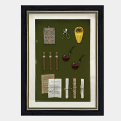 The Valdoro Vintage Cigar & Pipe Framed 3D Wall Art by Giant Sculptures displays a flask, cigar cutter, yellow lighter, cigars, pipes, and papers on a green background—an ideal wall decor piece for cigar and pipe enthusiasts.