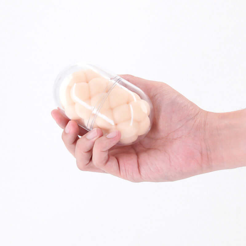 Pocket Pals Handy Stroker Bubbles White held in a hand, showcasing its compact design and bubble-textured interior.